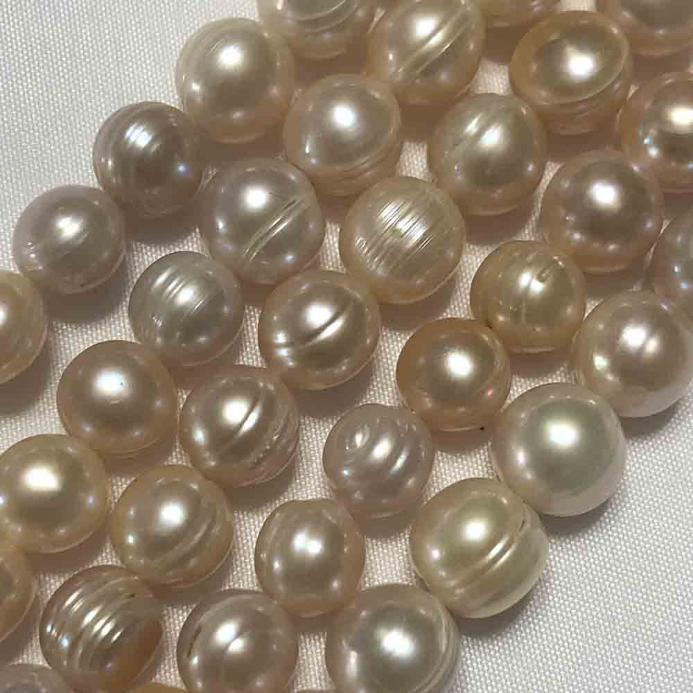 Large Peach Cream Semi-Smooth Round Cultured Pearls